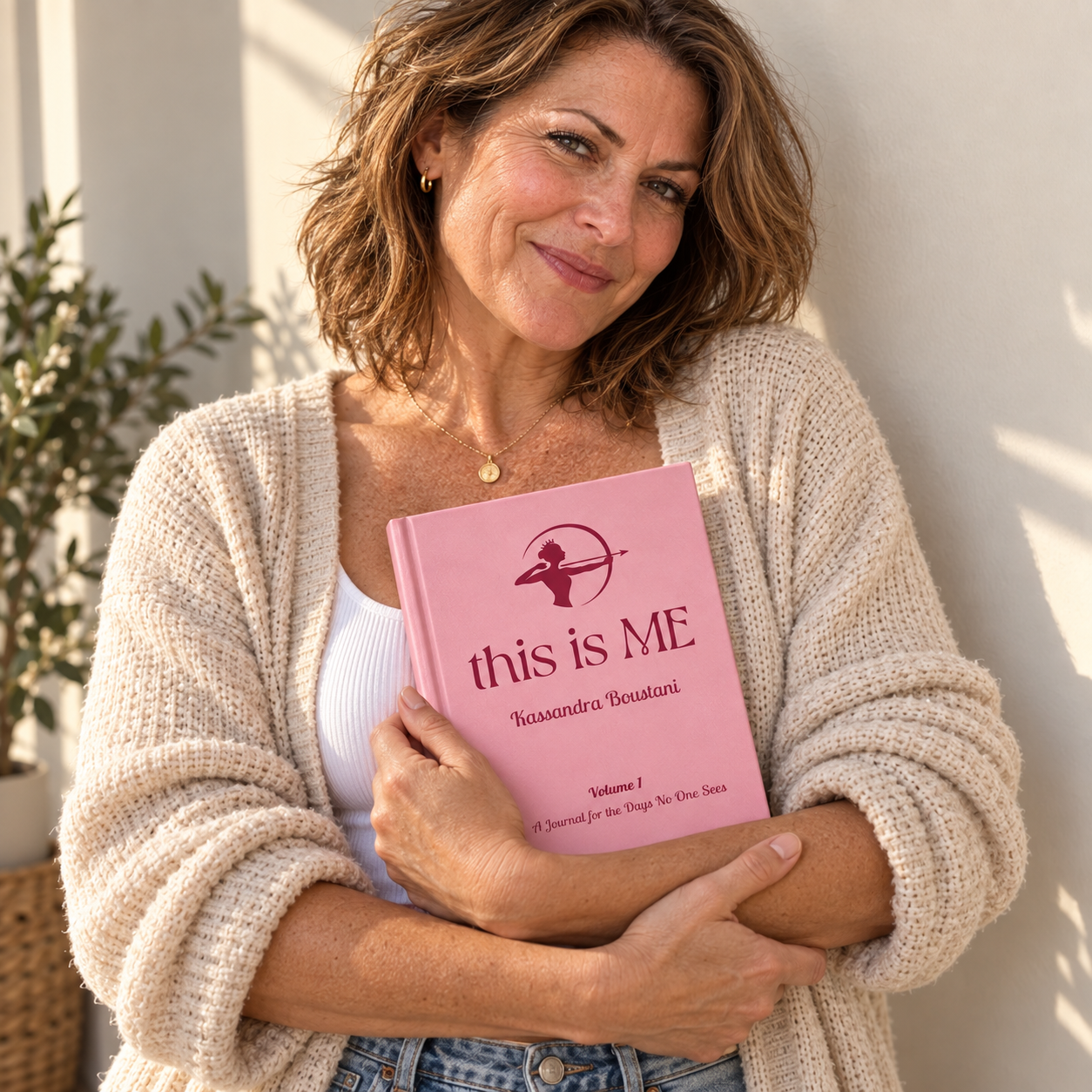 Confident woman holding the This Is Me guided healing journal